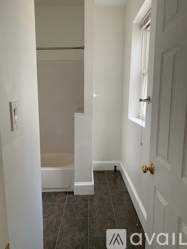 A bathroom with a tub and toilet in it.