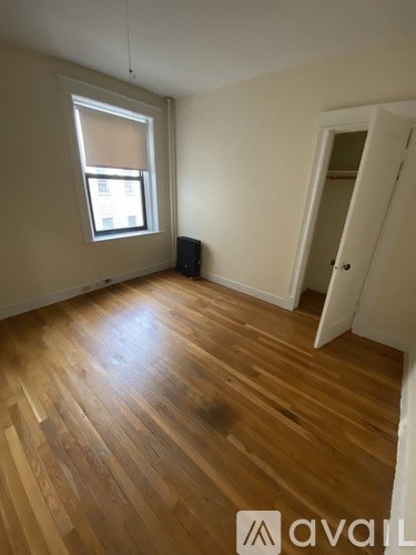 A room with wooden floors and a window.