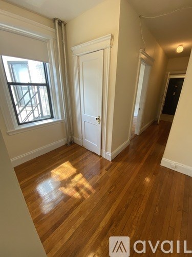 A room with wooden floors and a window.