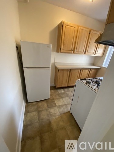 A kitchen with a white fridge and a white stove.