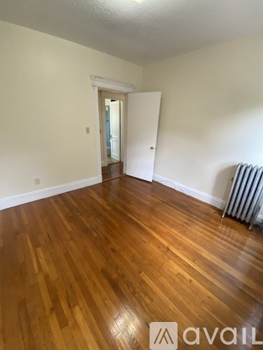 A room with wooden floors and a white door.