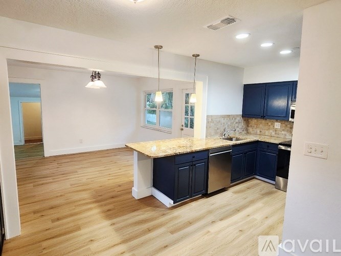 A kitchen with blue cabinets and a wooden island.