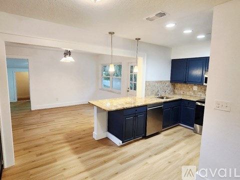 A kitchen with blue cabinets and a wooden island.