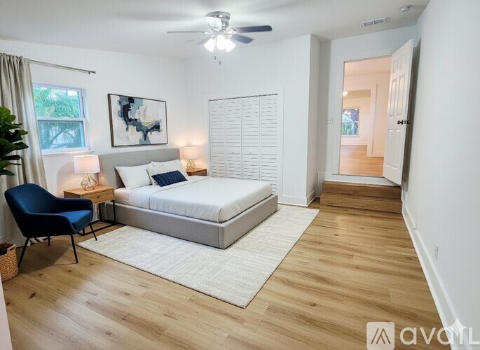 A bathroom with a toilet, sink and mirror.
