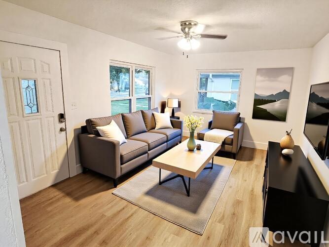 A kitchen with a marble island and wooden floors.