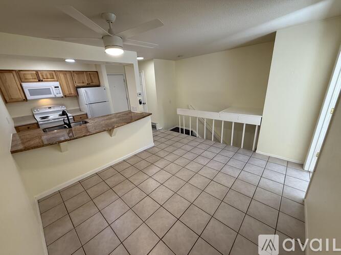 A kitchen with a refrigerator, microwave, and oven.