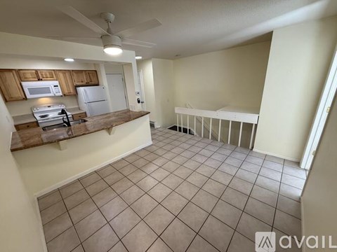 A kitchen with a refrigerator, microwave, and oven.