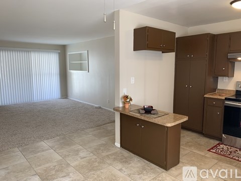 A kitchen area with brown cabinets and a countertop.