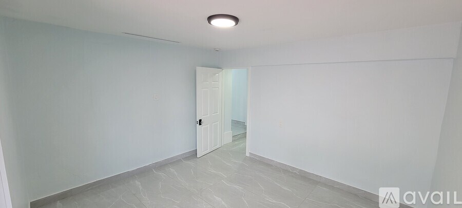 A spacious room with a door at the end.