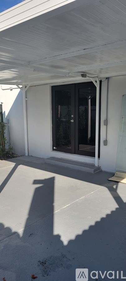 A white bathroom vanity with a sink and mirror.