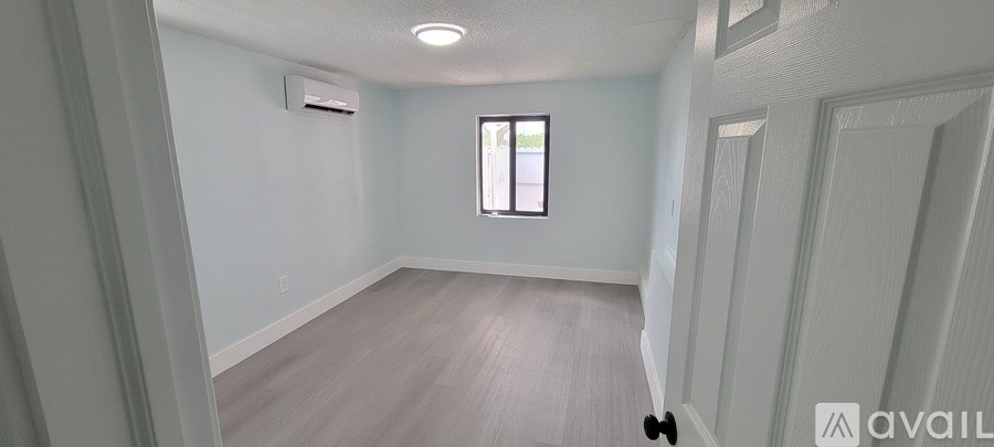 A room with a window and a door.