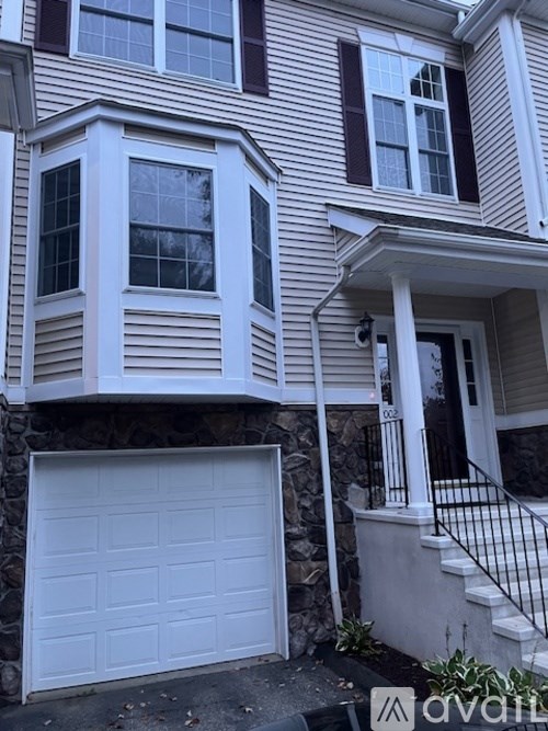 A white garage door is attached to a house.