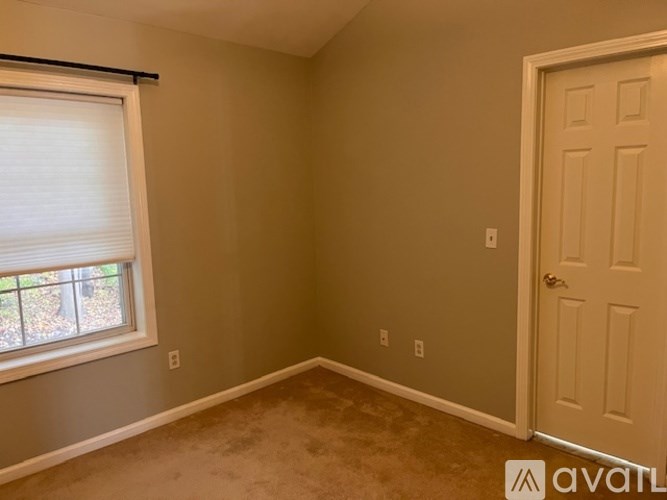 A room with a window and a door.