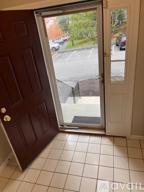 A view of a parking lot through a glass door.