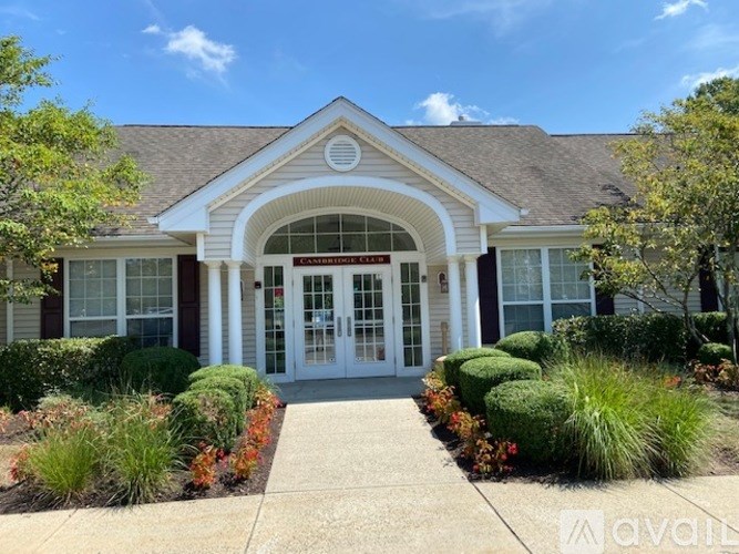 A building with a sign that says "AVAILABLE" in front of it.