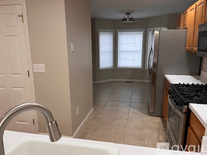 A kitchen with a white sink and a stove top oven.