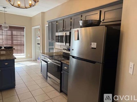 A kitchen with a stainless steel refrigerator and other appliances.