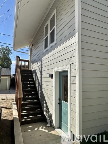 A house with a staircase leading to the front door.