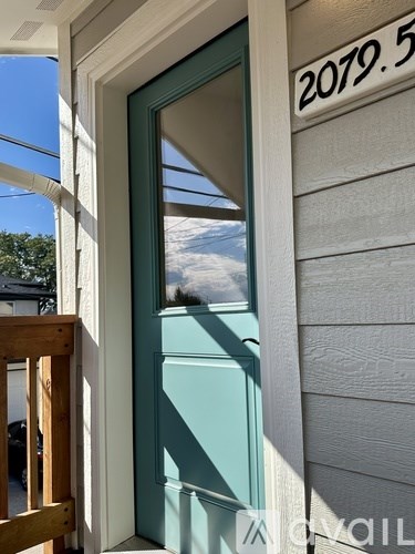 A door with a glass window and a number plate above it.