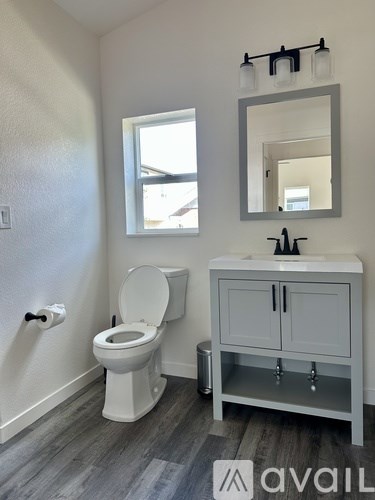 A white toilet sits next to a sink in a bathroom.