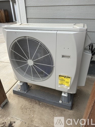 A large outdoor air conditioning unit sits on a concrete slab.