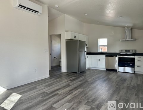 A kitchen with a refrigerator, stove, and oven.