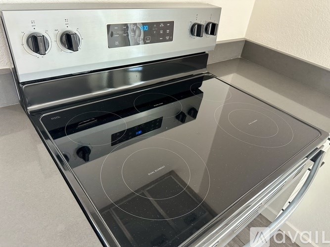 A modern stainless steel oven with a digital control panel and a glass door.