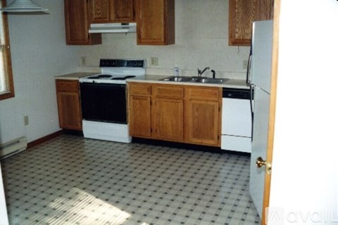 A kitchen with a black and white stove top oven.