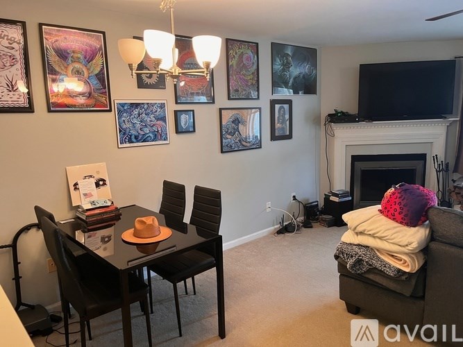 A living room with a fireplace and a dining table.