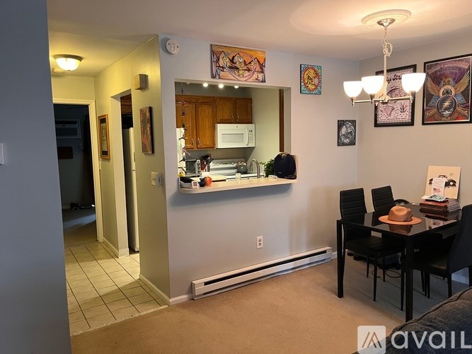 A kitchen with a dining table and chairs in the foreground.