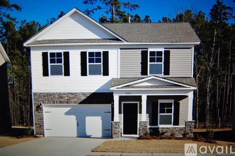 A two-story house with a garage is for sale.