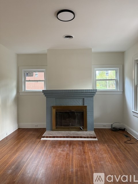 A kitchen with white cabinets and a red backsplash.