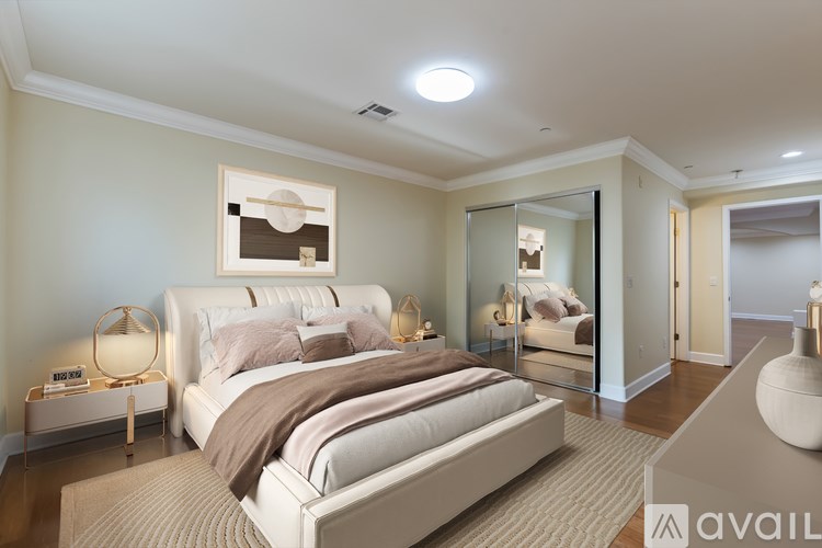 A bedroom with a large bed and a mirror on the wall.