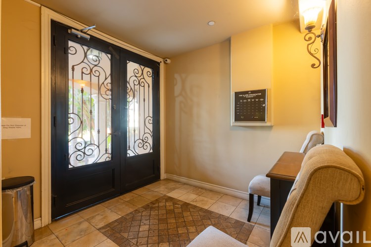 A room with a black door and a brown chair.