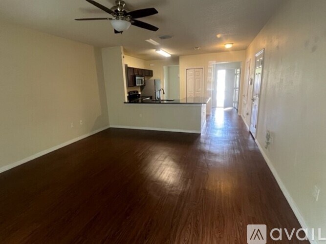 A room with wooden floors and a ceiling fan.