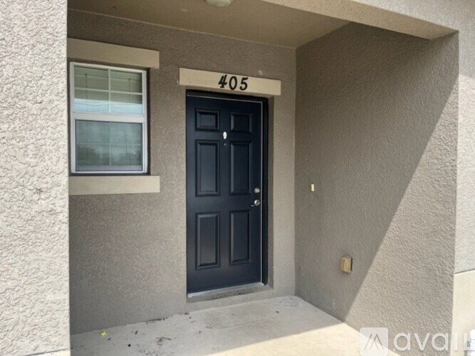 A black door with a glass window above it and a number 405 above the door.