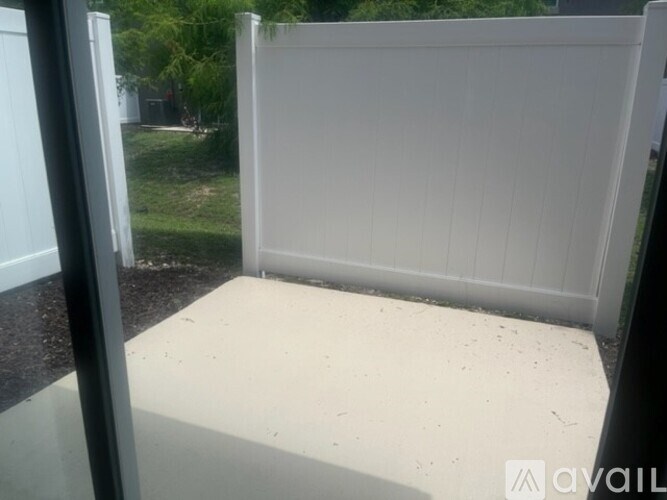 A white fence is in the foreground of the image.