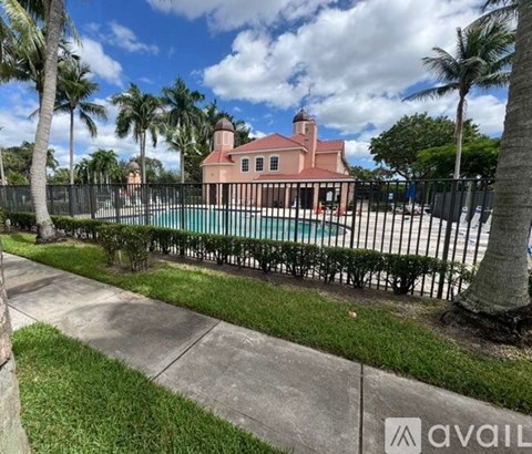 A house with a pool surrounded by a fence.