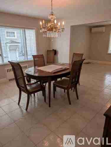 A dining room with a round table and chairs.