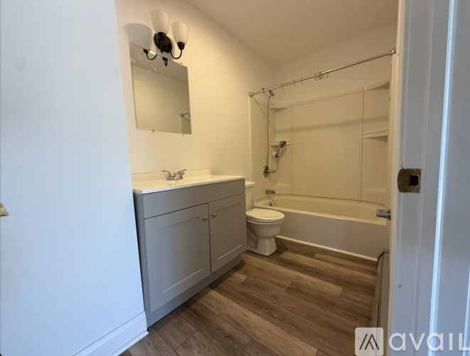 A bathroom with a toilet, sink, and bathtub.