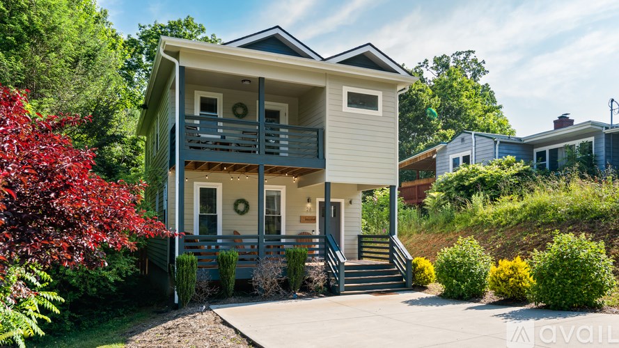 A two-story house with a balcony and a front porch.