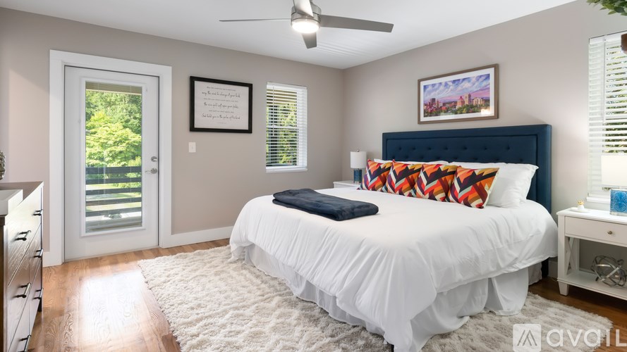 A bedroom with a bed, nightstand, and window with blinds.