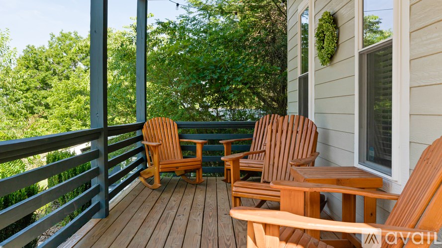 A wooden deck with two chairs and a bench.
