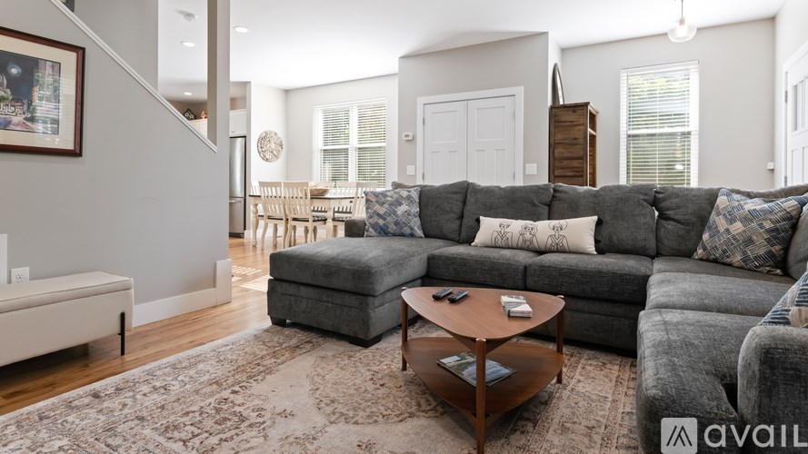 A living room with a grey couch and a coffee table.