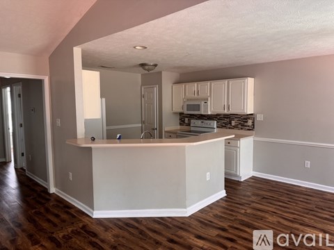 A kitchen with a counter and cabinets is available for rent.