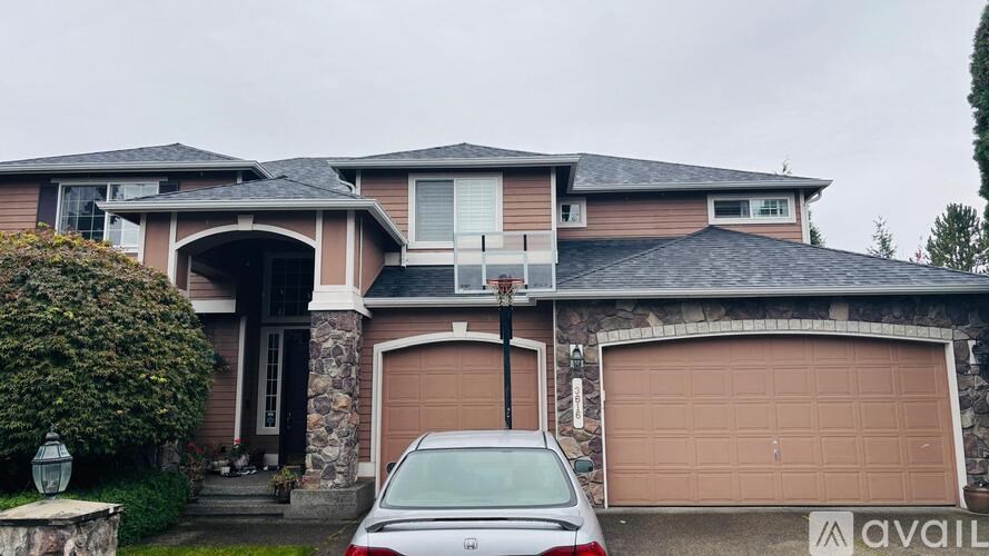 A house with a car parked in front of it.