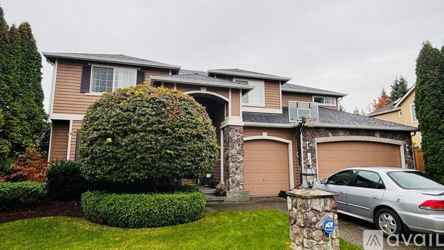 A house with a car parked in front of it.