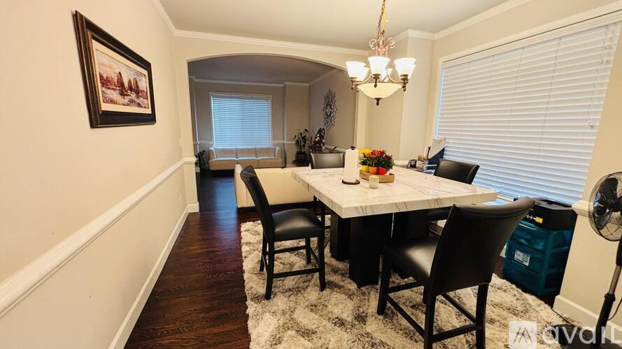 A dining room with a table set for four.