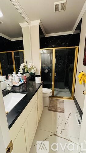 A bathroom with a sink, mirror, and toilet.