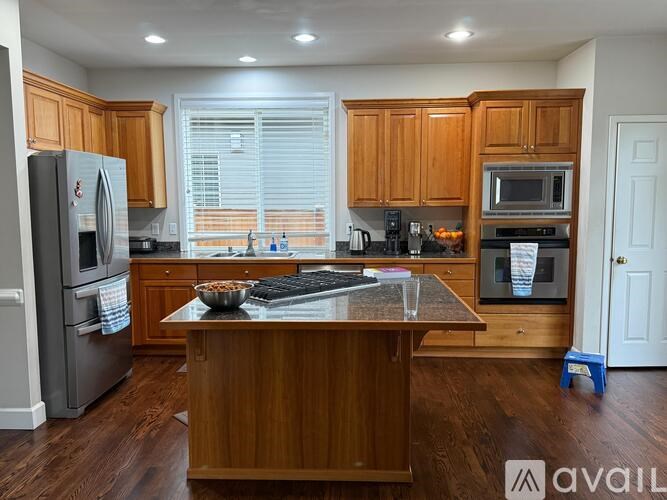 A kitchen with wooden cabinets and stainless steel appliances.